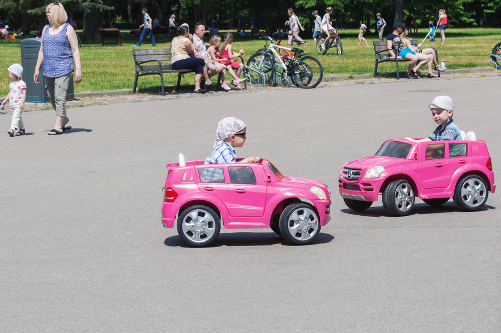 VILNIUS, LITHUANIA - MAY 29,2016: Two little boys driving toy electric cars in a park at sunny summer day in Vilnius, Lithuania